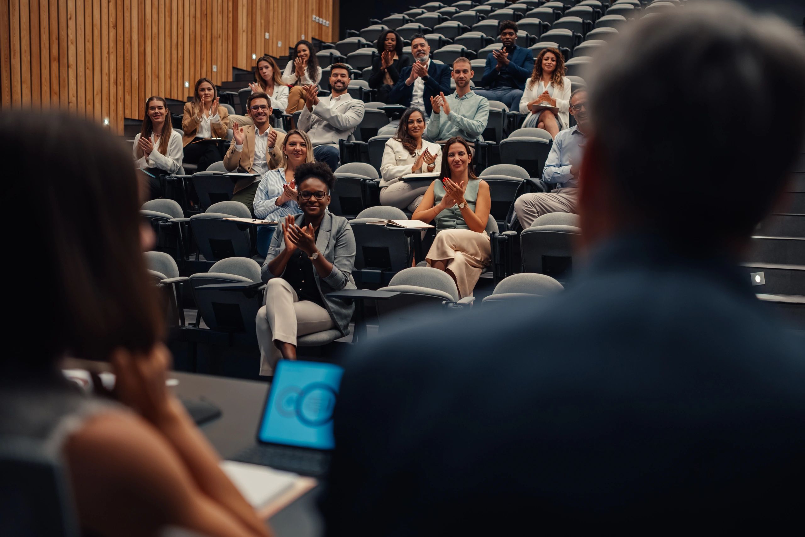 Business event audience applauding a presentation